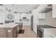 Spacious kitchen with island seating, stainless steel appliances, white cabinetry, and tile backsplash at 8634 Santa Cruz Dr, Port Charlotte, FL 33981