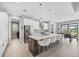 Bright kitchen featuring a large center island with seating, stainless steel appliances, and modern pendant lighting at 8634 Santa Cruz Dr, Port Charlotte, FL 33981