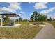 Community park featuring a shaded picnic pavilion, walking path, and lush green space for outdoor activities at 8634 Santa Cruz Dr, Port Charlotte, FL 33981