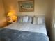 Inviting bedroom with a comfortable bed, soft lighting, and a relaxing atmosphere for restful sleep at 868 Baveno Dr, Venice, FL 34285