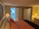 Well-lit bedroom featuring connecting bathroom and closet doors, and comfortable bedding at 868 Baveno Dr, Venice, FL 34285