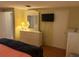 Bright bedroom with a TV, full-length mirror, and a calming atmosphere at 868 Baveno Dr, Venice, FL 34285