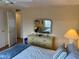 Comfortable bedroom with dresser, mirror and soft, inviting bedding and natural light at 868 Baveno Dr, Venice, FL 34285