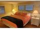 Inviting bedroom with two windows and nightstands on each side of the bed at 868 Baveno Dr, Venice, FL 34285