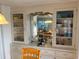 Dining room and hutch with built-in storage and display space for glassware and dishes at 868 Baveno Dr, Venice, FL 34285