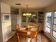 Dining room with wood table, chandelier, and built-in cabinets, adjacent to the kitchen at 868 Baveno Dr, Venice, FL 34285