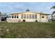 Inviting manufactured home with a covered porch, bright windows, and well-kept landscaping at 868 Baveno Dr, Venice, FL 34285