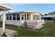 Charming manufactured home featuring a cozy sunroom and outdoor deck with a well-maintained lawn at 868 Baveno Dr, Venice, FL 34285