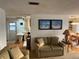 Cozy living space with comfortable seating, beach-themed decor, and views into the kitchen at 868 Baveno Dr, Venice, FL 34285