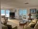 Inviting living room featuring comfortable seating, a glass-top coffee table, and natural light at 868 Baveno Dr, Venice, FL 34285