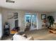 Living room view with comfortable seating, a TV, and access to an adjacent sunroom at 868 Baveno Dr, Venice, FL 34285