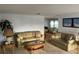 Spacious living room featuring plush sofas, a glass coffee table, and neutral tones at 868 Baveno Dr, Venice, FL 34285