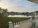 Scenic view of a tranquil pond surrounded by well-maintained manufactured homes and lush greenery at 868 Baveno Dr, Venice, FL 34285