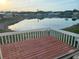 Peaceful view of a community pond from a deck, surrounded by mature trees and manufactured homes at 868 Baveno Dr, Venice, FL 34285