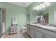 Well-lit bathroom featuring a double sink vanity, and an enclosed glass shower at 9118 Coachman Dr, Venice, FL 34293