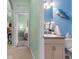 Bathroom and bedroom view with vanity, toilet, and neutral-colored walls at 9118 Coachman Dr, Venice, FL 34293