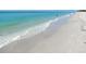 Tranquil ocean waves washing onto a sandy beach at 9118 Coachman Dr, Venice, FL 34293