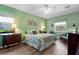 Bedroom featuring a ceiling fan, a comfortable bed, and neutral-colored walls at 9118 Coachman Dr, Venice, FL 34293