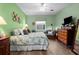 Bedroom featuring a ceiling fan, a comfortable bed, and neutral-colored walls at 9118 Coachman Dr, Venice, FL 34293
