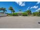 Community clubhouse featuring lush landscaping, convenient parking, and mailbox access in a picturesque setting at 9118 Coachman Dr, Venice, FL 34293