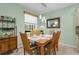 Dining room with seating for six, modern lighting, and neutral paint at 9118 Coachman Dr, Venice, FL 34293