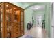 Bright entryway featuring tile flooring, decorative glass, and an elegant cabinet at 9118 Coachman Dr, Venice, FL 34293