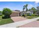 Charming home featuring a brick driveway, meticulously manicured landscaping, and a two-car garage at 9118 Coachman Dr, Venice, FL 34293