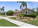 Charming home featuring a brick driveway, meticulously manicured landscaping, and a two-car garage at 9118 Coachman Dr, Venice, FL 34293