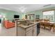 Open-concept kitchen with island, granite countertops and stainless steel appliances at 9118 Coachman Dr, Venice, FL 34293