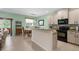 Bright kitchen with island seating, modern appliances, and an adjacent dining area at 9118 Coachman Dr, Venice, FL 34293