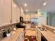 Bright kitchen with granite countertops, stainless steel appliances, and mosaic backsplash at 9118 Coachman Dr, Venice, FL 34293