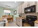 Kitchen area with granite countertops, stainless steel appliances, and light-colored cabinets at 9118 Coachman Dr, Venice, FL 34293