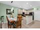 Kitchen and dining area with stainless steel appliances and granite countertops at 9118 Coachman Dr, Venice, FL 34293