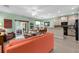 Open-concept living room and kitchen area with sliding doors to an outdoor dining area at 9118 Coachman Dr, Venice, FL 34293