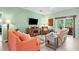 Comfortable living room area, featuring cozy seating and sliding door access to outdoor patio at 9118 Coachman Dr, Venice, FL 34293