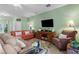 Inviting living room with comfortable seating, a media center, and lots of natural light at 9118 Coachman Dr, Venice, FL 34293