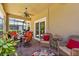 Outdoor patio featuring ceiling fan, seating and a table with place settings at 9118 Coachman Dr, Venice, FL 34293