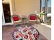 Relaxing outdoor patio area with chairs, a small table, and a colorful rug at 9118 Coachman Dr, Venice, FL 34293