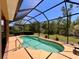 Screened-in pool boasts sparkling blue water and a tranquil setting at 9118 Coachman Dr, Venice, FL 34293