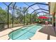 The screened-in pool area offers privacy and a relaxing retreat surrounded by lush greenery at 9118 Coachman Dr, Venice, FL 34293