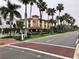A scenic street view with palm trees lining the road, leading to a Bank of America building at 9118 Coachman Dr, Venice, FL 34293