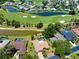 Aerial view of a home adjacent to a golf course with water features and lush landscaping at 915 S Doral Ln, Venice, FL 34293