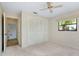 Bright bedroom features a closet with sliding doors and a large window for natural light at 915 S Doral Ln, Venice, FL 34293