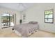 Bright bedroom featuring views of the backyard, carpet flooring, and access to the pool area at 915 S Doral Ln, Venice, FL 34293
