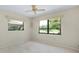Bright bedroom with golf course views from the two large windows and neutral carpet at 915 S Doral Ln, Venice, FL 34293