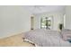 Bright bedroom with sliding door access to the pool area and carpet flooring at 915 S Doral Ln, Venice, FL 34293