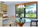 Bright breakfast nook with a glass table and views of lush greenery through a large window at 915 S Doral Ln, Venice, FL 34293