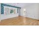 Bright dining room with wainscotting, decorative mirrors, and access to the kitchen and lanai at 915 S Doral Ln, Venice, FL 34293
