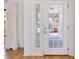 Bright entryway featuring beautiful hardwood floors and a clear glass door at 915 S Doral Ln, Venice, FL 34293