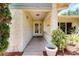 Inviting front porch with stone accents, decorative columns, and a charming entryway at 915 S Doral Ln, Venice, FL 34293